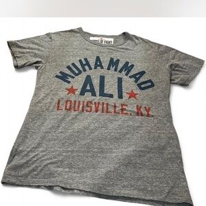 Muhammad Ali center roots of fight shirt